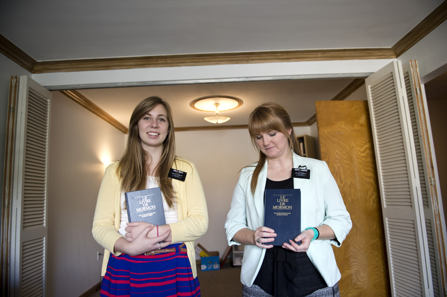 Sister Smith & sister Landeen holding their book of Mormon.
