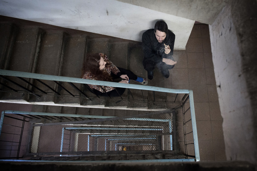 Andrei, a student of the Moscow Art Institute, lighting his pipe in the staircase of his dormitory.
