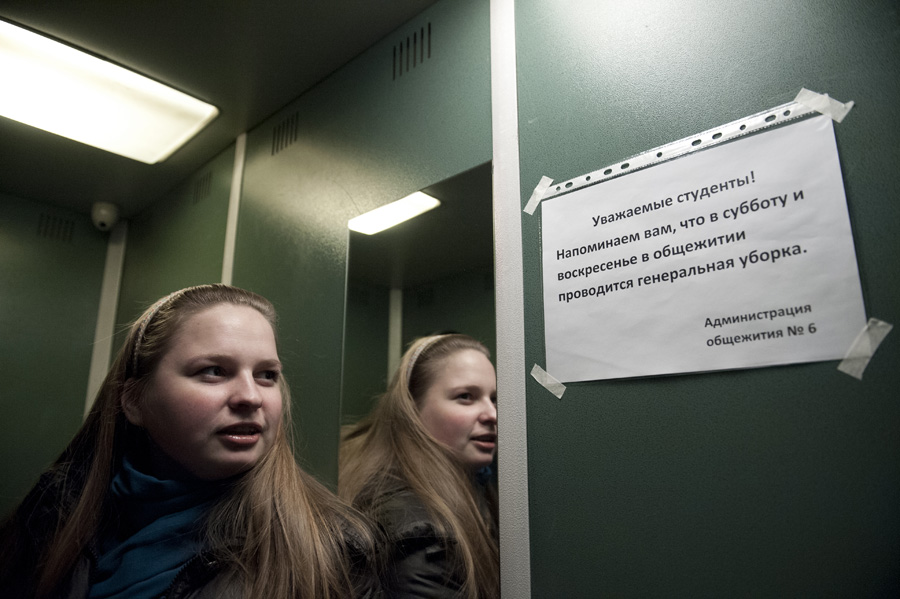 Elena Gasyukova, a 24-year old student at the Higher School of Economics, is looking at a sign in the elevator that says, 