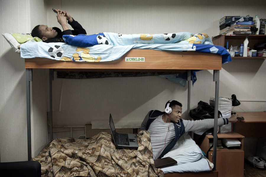 Nigerian students Christopher Onoja (top), 22, and Issac Ismaila (bottom), 24, both came to Russia on a scholarship. “Honestly, I don’t like anything about this place because the rooms are full of roaches and bed bugs. We renovated— the lighting, the wallpaper, everything — but it was a mess when we arrived,” Onoja said.