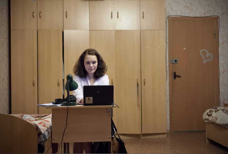 Yulia Mishina, a student from Barnaul, Siberia, working at her desk in her room.